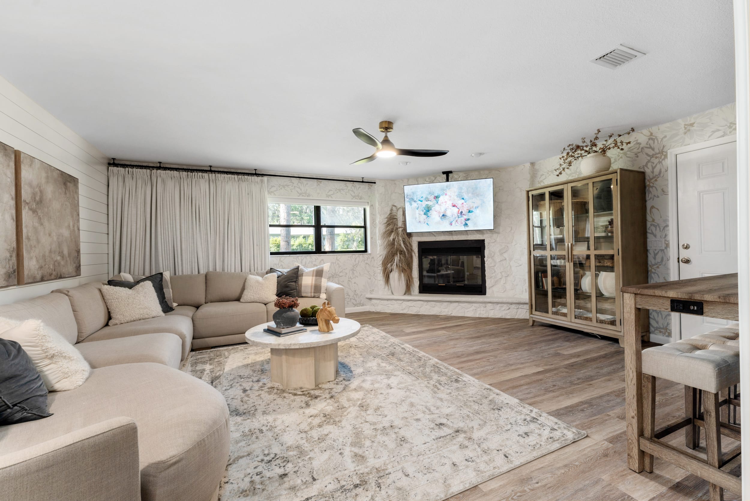 Kelli Bateman's living room photo with large beige sectional and marble coffee table